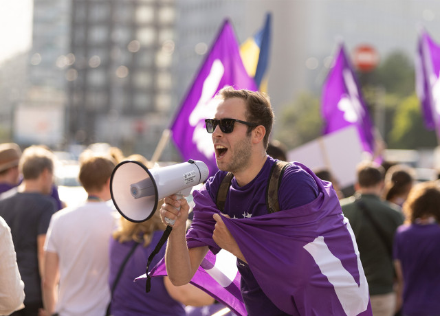 Volter with megaphone in crowd