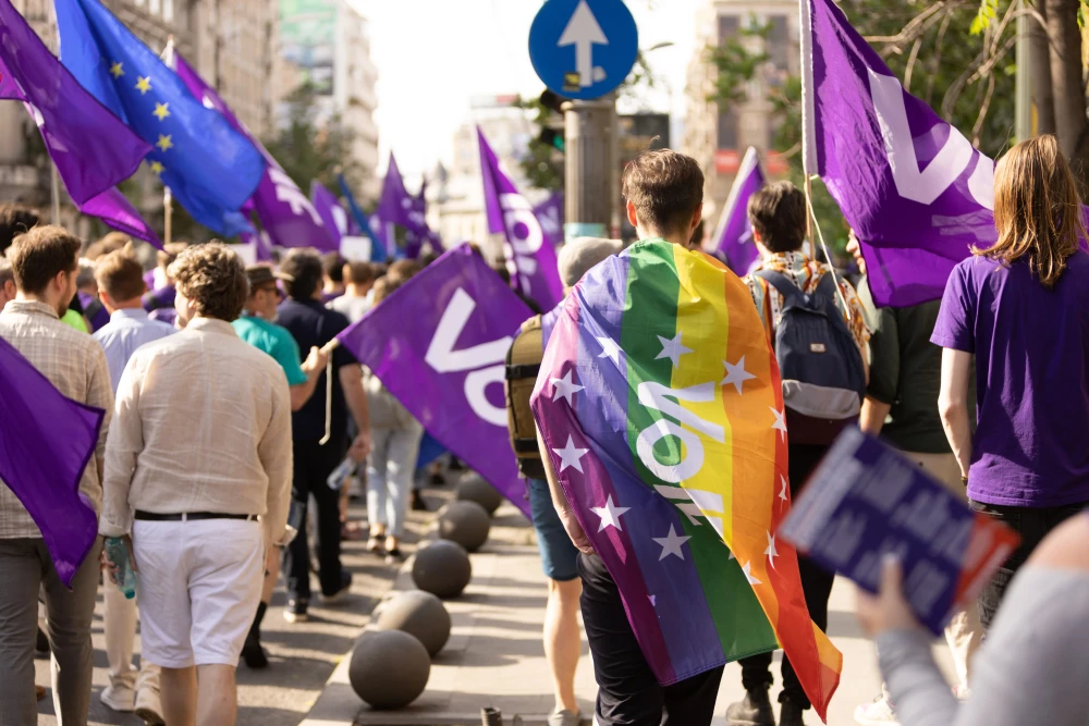 Volters marching in Bucharest with rainbow flag