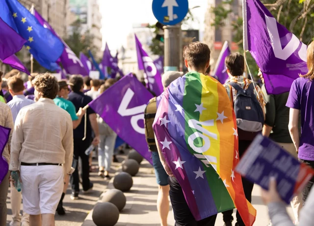 Volters marching in Bucharest with rainbow flag