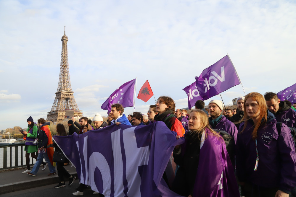 Group of Volters marching on the streets of Paris with the Eiffel Tower on the background